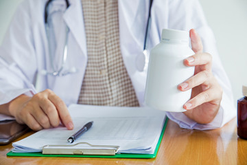 Women doctor holding a bottle of medicine.healthy care concept.