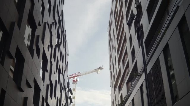 4K gimbal video with a medium low angle and tilt motion of an office and apartment building in daylight in the Barcode quarter of the new, modern and popular Bjoervika district in Oslo Norway.