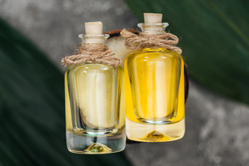 top view of bottles with coconut oil and corks on coconut half