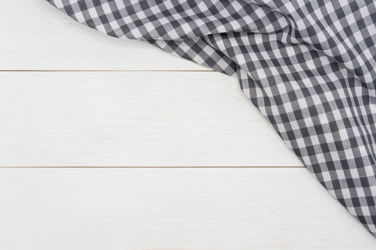 Wrinkled Grey Gingham Fabric On Rustic White Wood Plank Background, With Copy Space. 