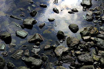 A rocky cove with calm waves