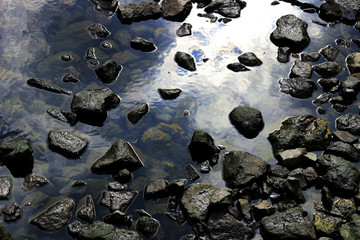 A rocky cove with calm waves