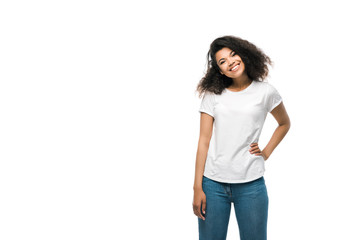 happy african american girl in white t-shirt standing with hand on hip isolated on white