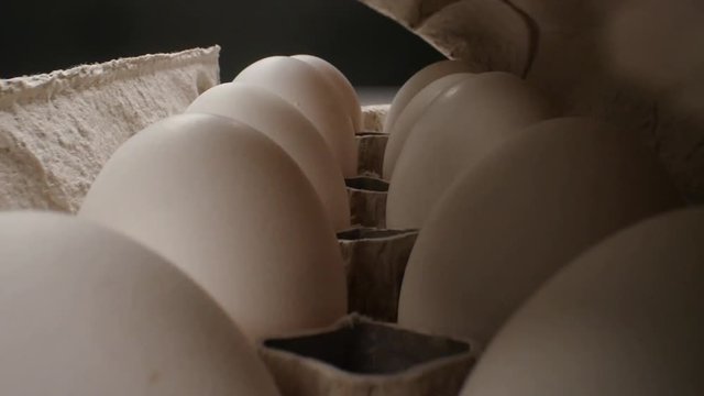 Raw fresh egg in pack on whitetable, slide shoot