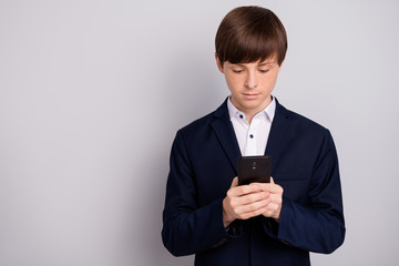 Portrait of focused concentrated little man male hold hand modern technology use user news feed read blogging wear black white shirt blazers jacket stylish style isolated grey argent background