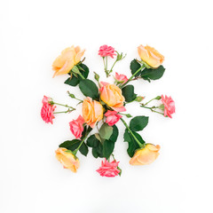 Pink and orange roses and leaves on white background. Flat lay, top view