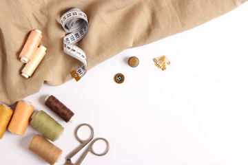 sewing accessories on white background top view.