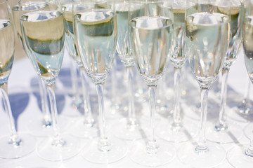 A lot of wine glasses in a row. Luxury glasses for alcohol. Wine glasses with wine on a table outside