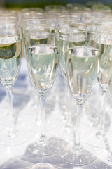 A lot of wine glasses in a row. Luxury glasses for alcohol. Wine glasses with wine on a table outside