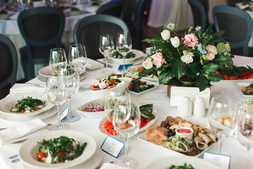 of the dishes and food on the served table.  long served feast table.festive table in the restaurant.Interior of the banquet hall in the cafe.banquet table in the restaurant.place of celebration
