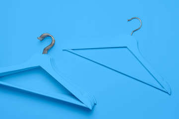 Creative fashion concept. Flat lay top view colored wooden hangers on blue background minimalism...