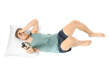 Obraz premium Sleepy man with alarm clock in bed
