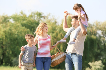 Fototapeta premium Happy family walking in park on summer day
