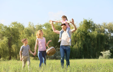 Happy family walking in park on summer day