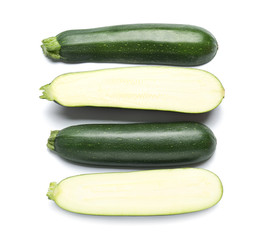 Fresh zucchini squashes on white background