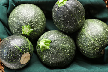 Fresh zucchini squashes in basket