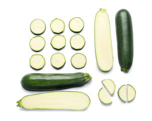 Cut zucchini squashes on white background