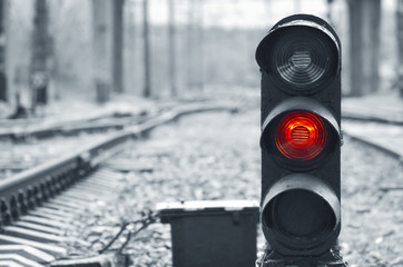 Traffic light shows red signal on railway. Red light