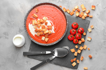 Bowl of tasty tomato cream soup on grunge background