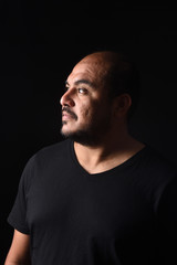 Fototapeta premium portrait of a latin american man on black background