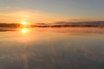 Fototapeta na wymiar lake sun sunrise fog reflection