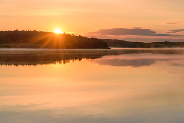 Fototapeta na wymiar lake sun sunrise fog reflection