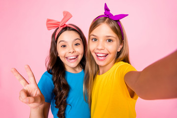 Close up photo of cheerful children make photo v-signs wear t-shirt headbands long wavy hairstyle...