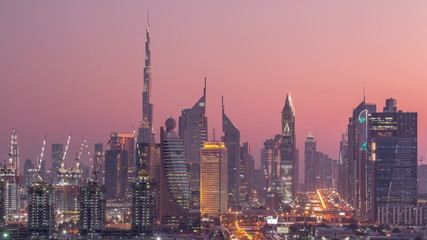 Fototapeta na wymiar Dubai skyline after sunset with beautiful city center lights and Sheikh Zayed road traffic timelapse, Dubai, United Arab Emirates