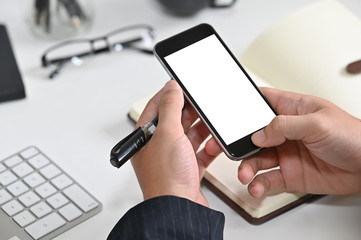 Closeup hands' businessman using mockup smartphone with empty screen.