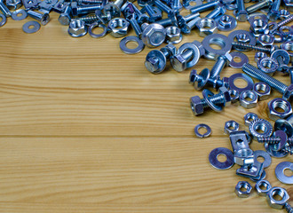 screws and bolts on the wooden table