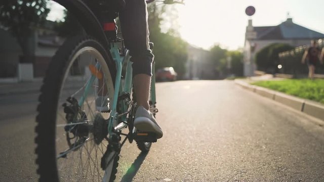 Girl Kid Riding Bike in Summer in City at Beautiful Sunset  in Slow Motion