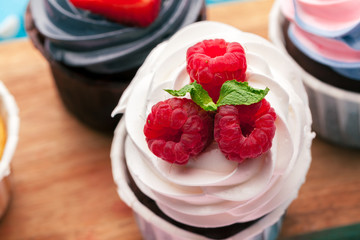 Side view of yummy cupcakes with assorted flavor. Shot on the table