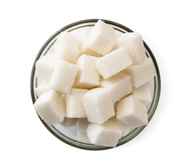 Refined sugar cubes in a glass plate on a white. The view of the top.
