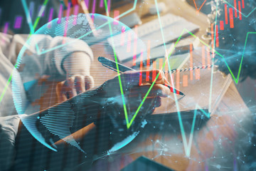 Financial forex charts displayed on woman's hand taking notes background. Concept of research. Double exposure