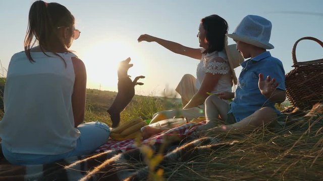 Family on a picnic playing with a dog