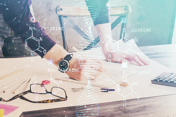Man's hands working with notes background. Genetic engineering and gene manipulation concept.