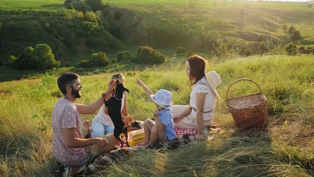 Family spending time together on a picnic with their dog