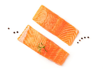 Two slices of salmon with black pepper and rosemary, shot from above on a white background with copy space