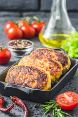 Chicken cheese vegetable rissoles in cast iron skillet. Selective  focus, space for text.