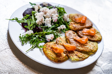 Pancakes with greek salad and salmon