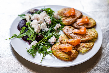 Pancakes with greek salad and salmon