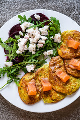 Pancakes with greek salad and salmon