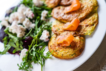 Pancakes with greek salad and salmon