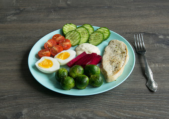 Chicken fillet, Brussels sprouts, eggs, tomatoes, cucumbers, white sauce