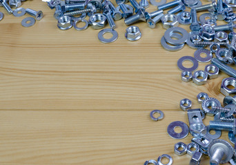 screws and bolts on the wooden table