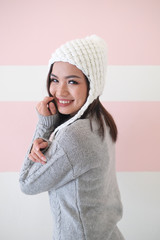 Asian girl, shot body length, is wearing a winter outfit with a cute emotion