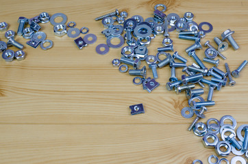 : screws and bolts on the wooden table