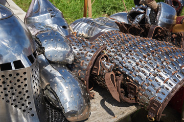 Armor of participants in the competition for the Medieval Battle. Тhеrе are a helmet, plate armor, bracers  and metal mittens © arostynov
