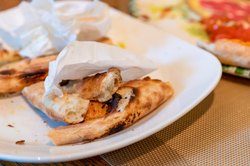 Pizza leftovers on a plate, pizza crust.Pizza leftovers, pizza crust