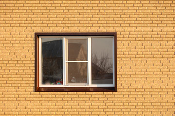 A window in a house with brick walls
